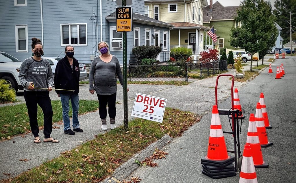 Residents of Lynde Street setting up a temporary traffic calming installation.
