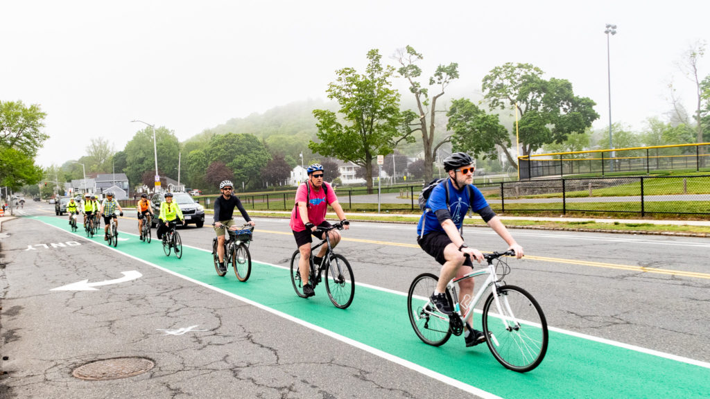 A group of bike riders use the painted bike lane on Main Street in Melrose, MA
